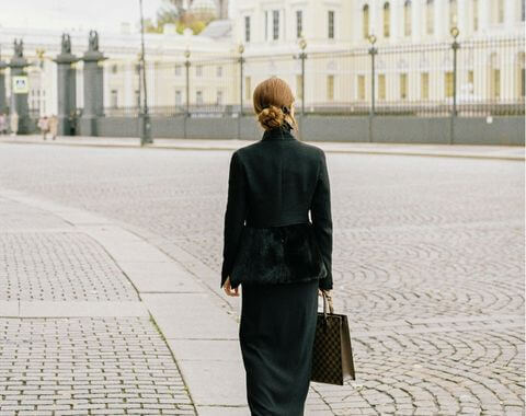 Woman walking along a path on a bright day