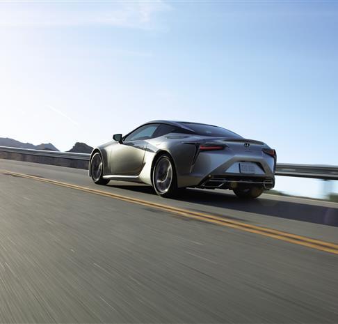 Lexus sedan driving on road 