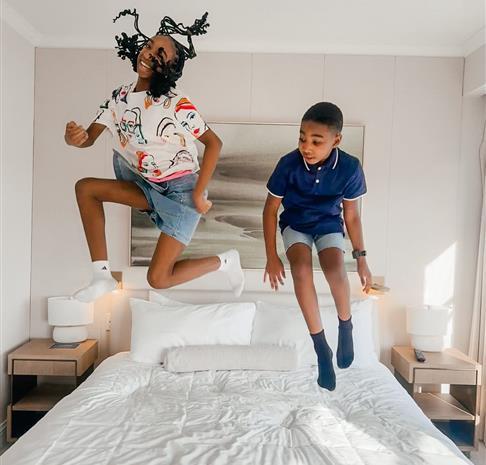 children on bed in suite excited for the day ahead