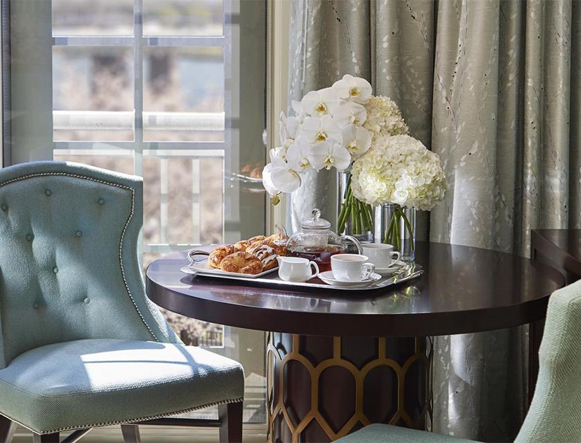 A blue chair next to a table