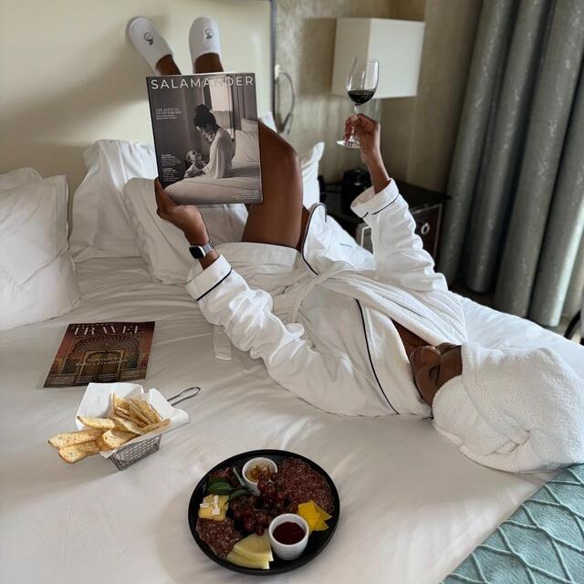 woman reading magazine in bed