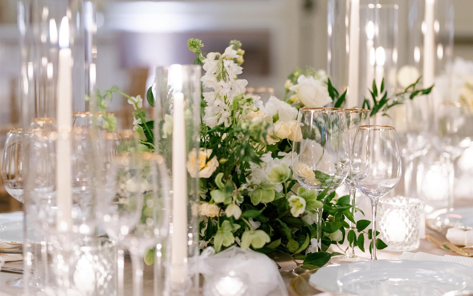 A table with candles and flowers on top
