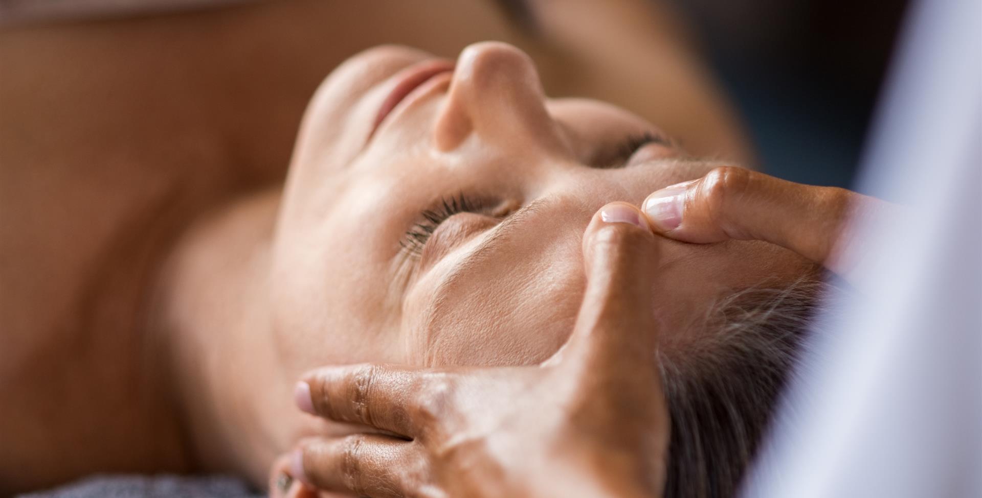 Woman getting face massaged